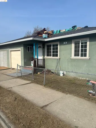 a front view of a house with a yard and a garage
