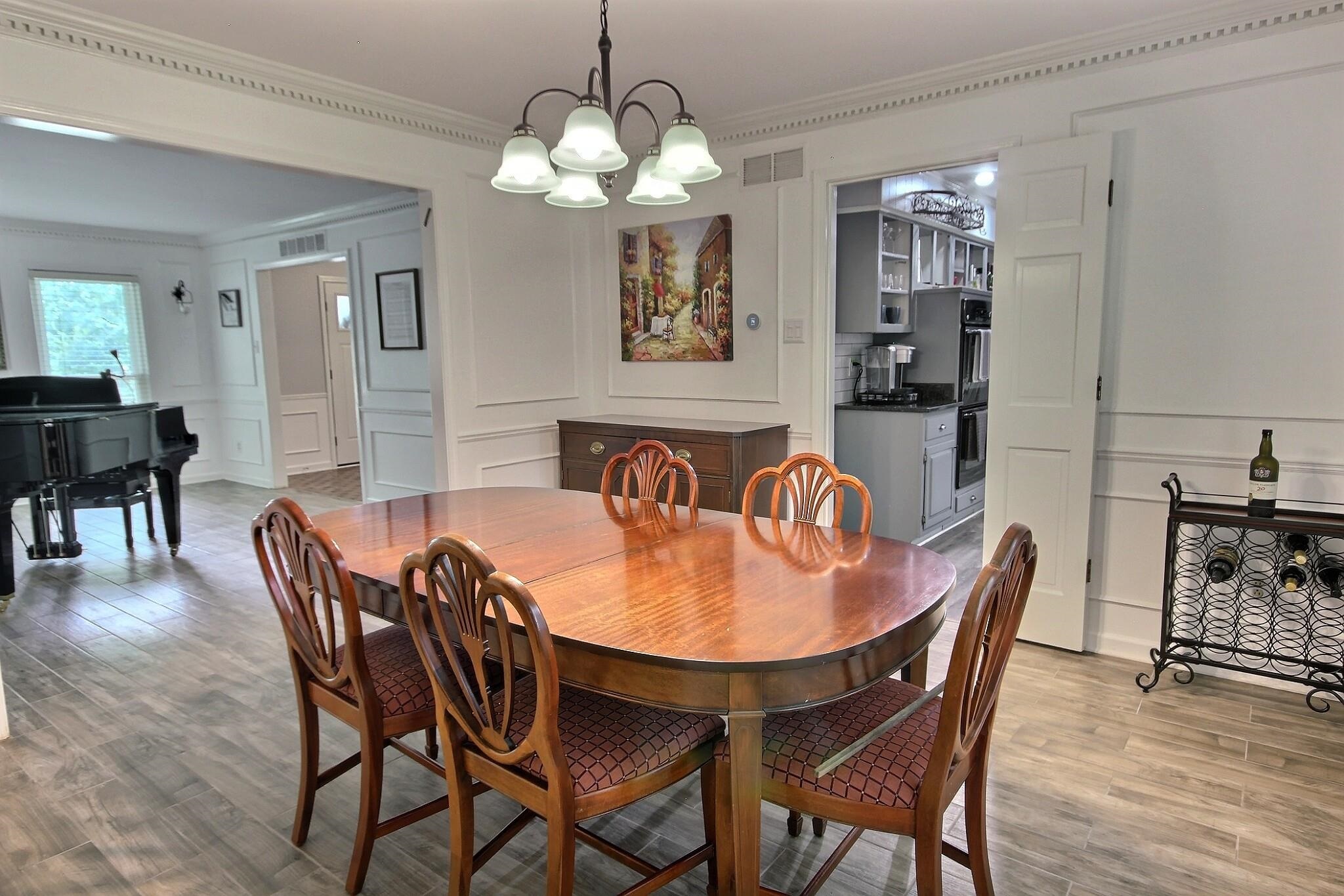 177 South Walnut Bend Road Memphis, TN 38018 - Photo 13 of 34 a view of a dining room with furniture wooden floor and chandelier