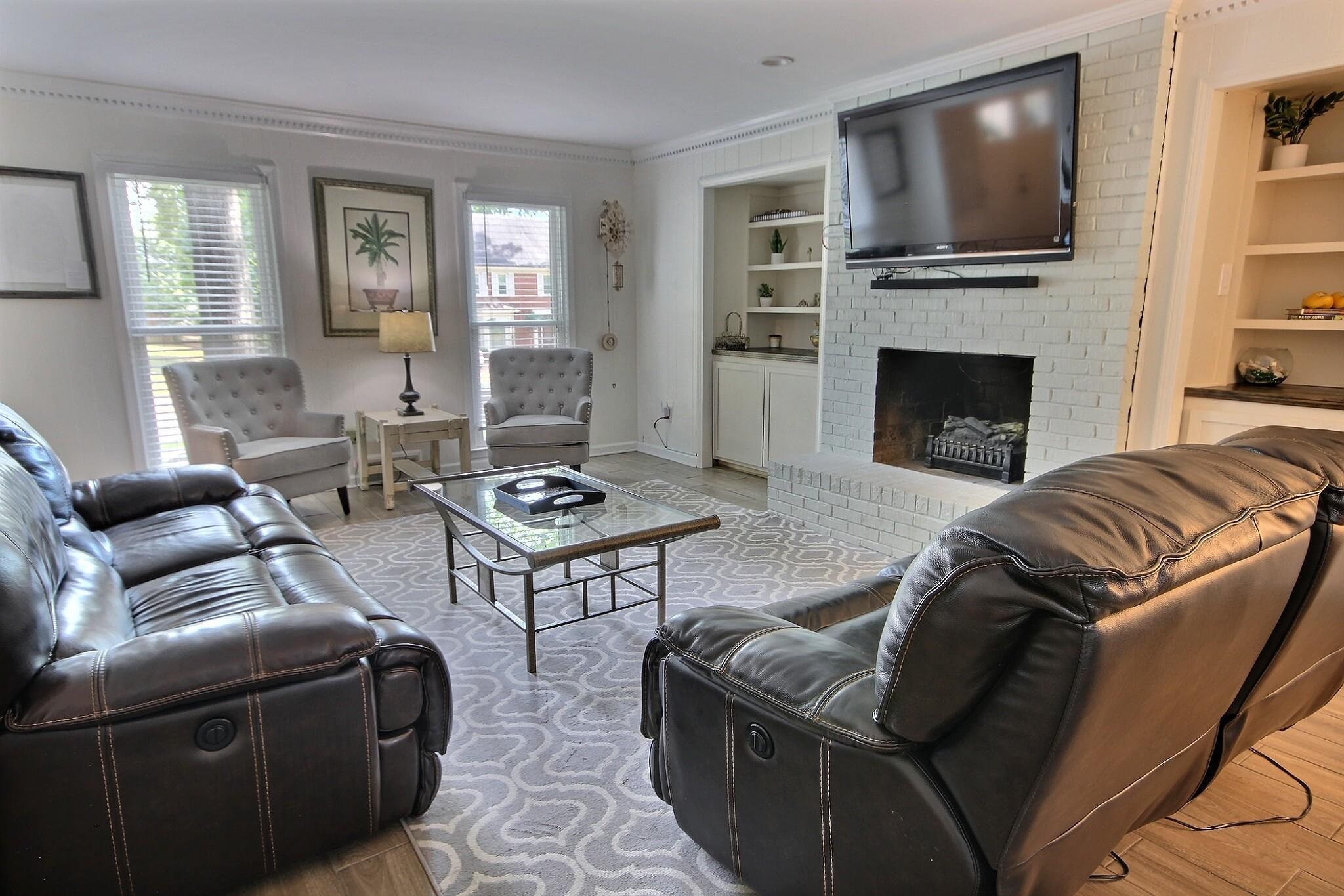 177 South Walnut Bend Road Memphis, TN 38018 - Photo 6 of 34 a living room with furniture a flat screen tv and a fireplace