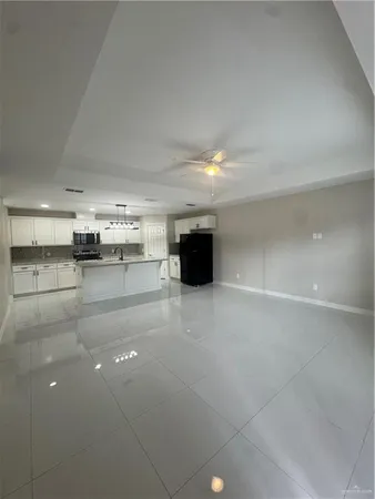 a view of kitchen and refrigerator in a center