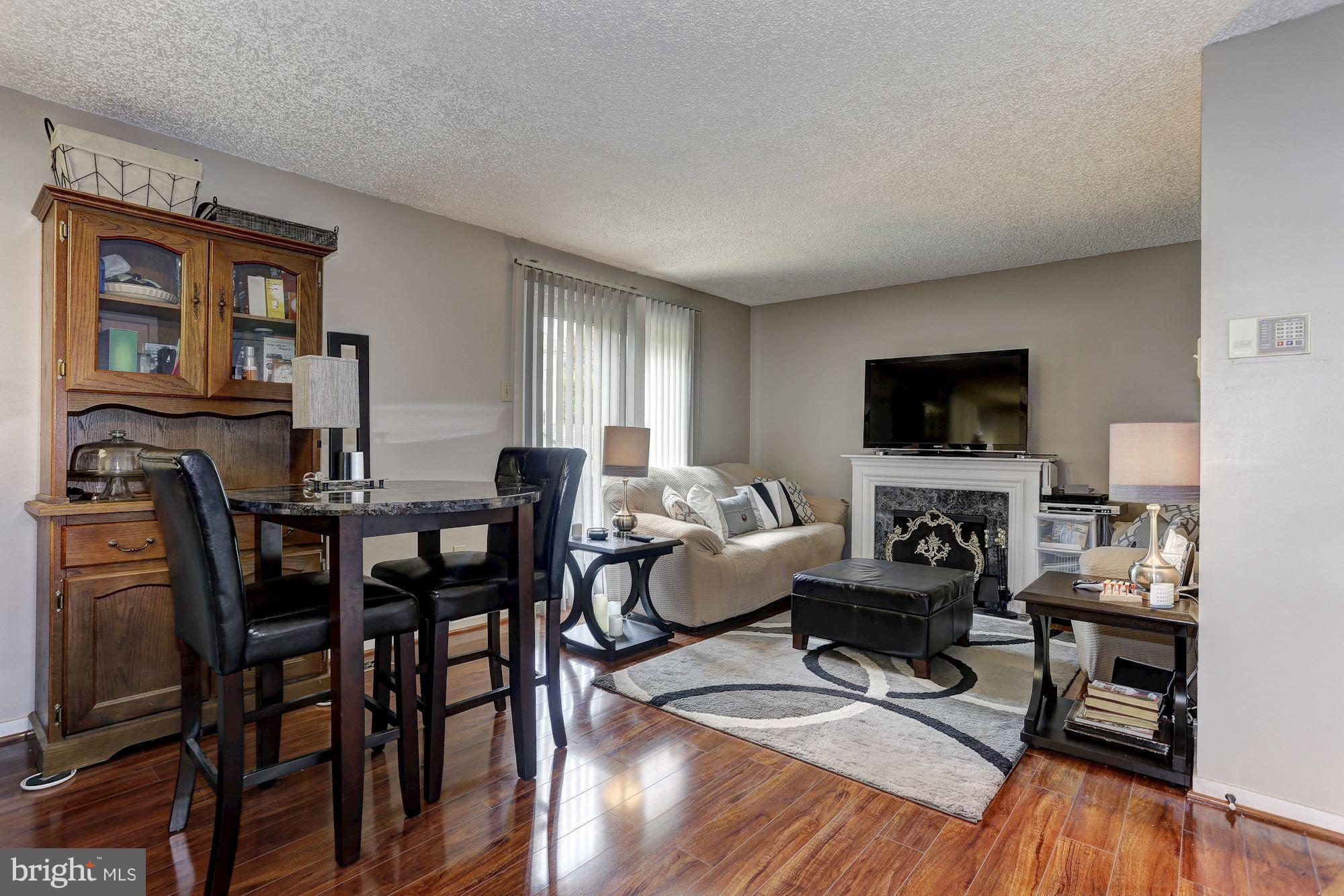 2302 Crossett Road Baltimore, MD 21237 - Photo 14 of 30 a living room with furniture a flat screen tv and kitchen view