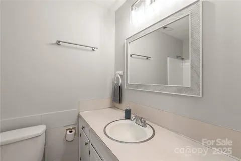 a white toilet sitting next to a bath tub