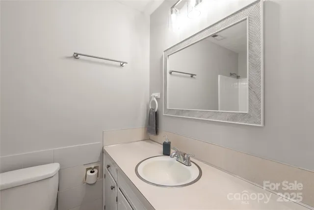 a white toilet sitting next to a bath tub