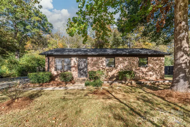a view of a house with pool and sitting area