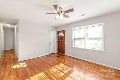 a view of a big room with wooden floor and closet