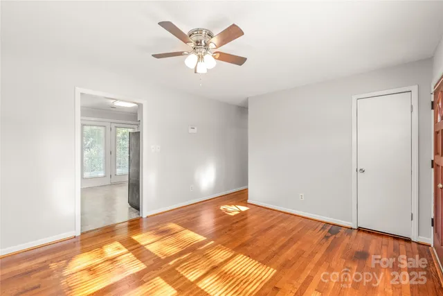 a kitchen with a refrigerator a stove top oven and white cabinets