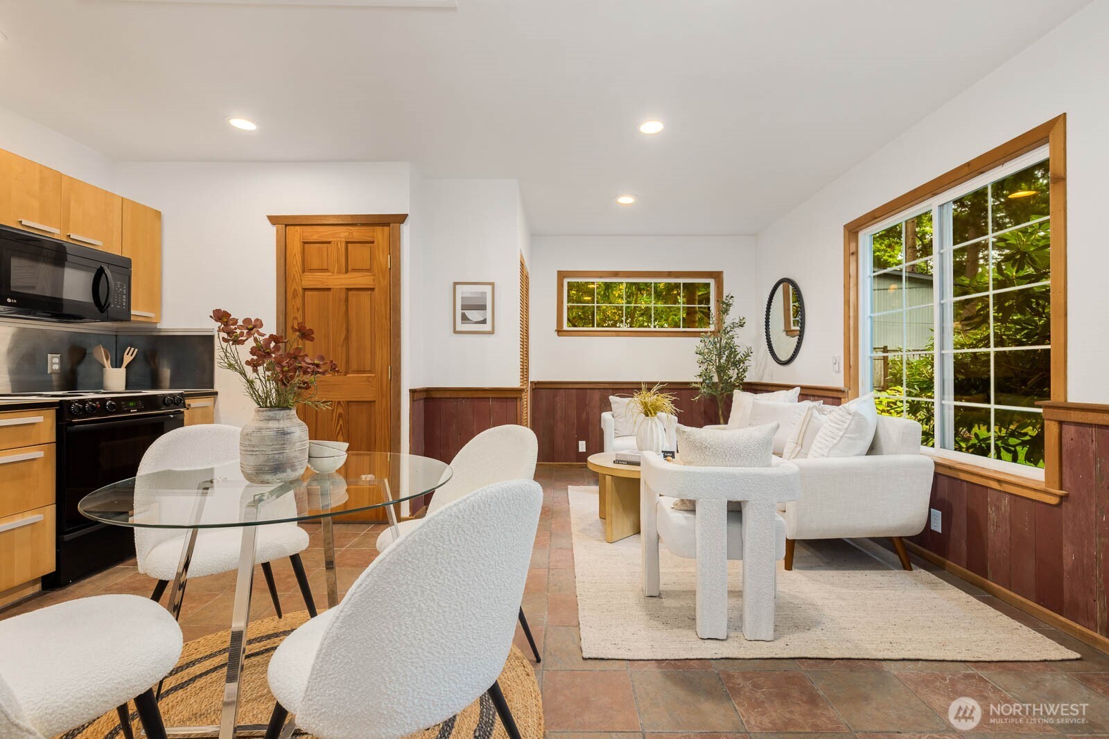 17110 66th Place West Edmonds, WA 98026 - Photo 30 of 38 a living room with furniture a flat screen tv and a table
