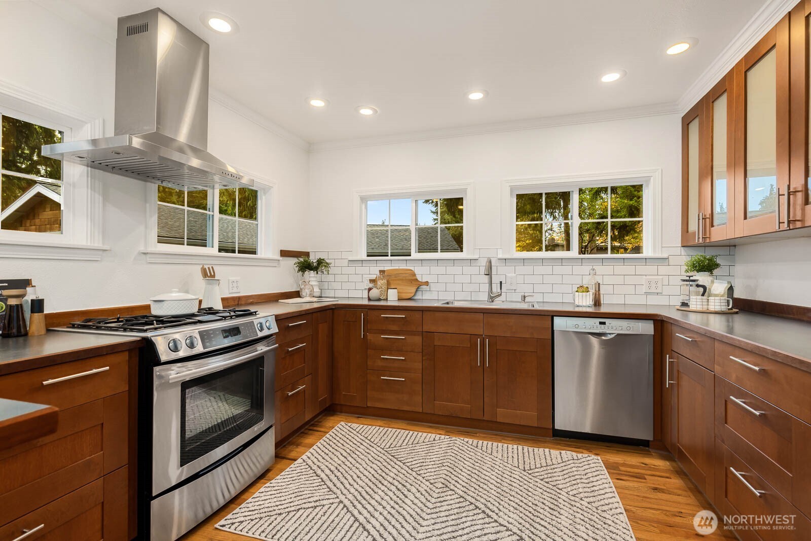 17110 66th Place West Edmonds, WA 98026 - Photo 10 of 38 a kitchen with stainless steel appliances granite countertop wooden cabinets stove top oven and sink