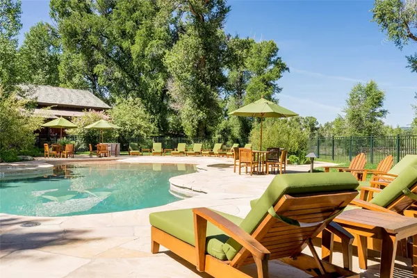 a view of a patio with a table and chairs under an umbrella
