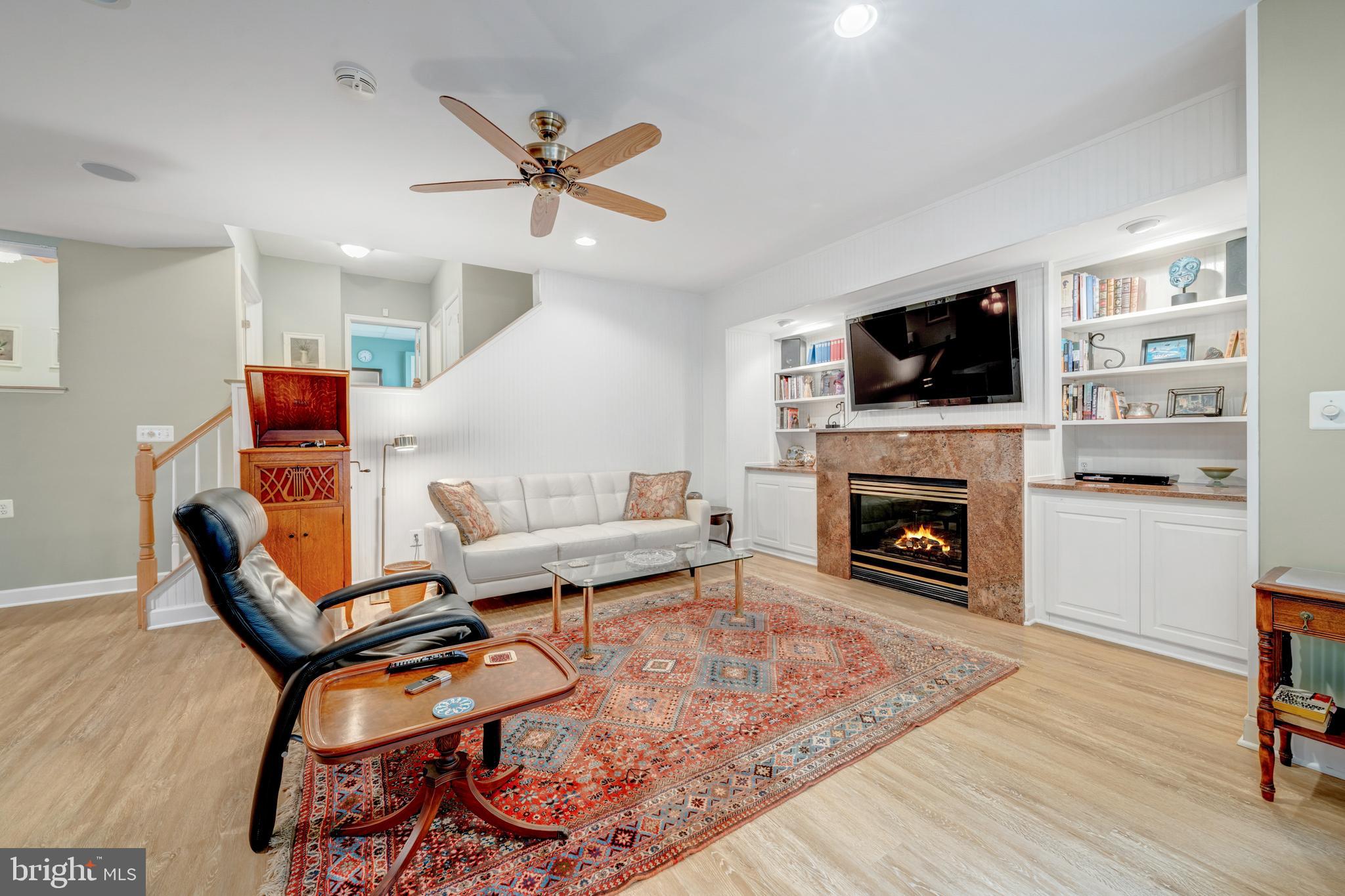 1925 Logan Manor Drive Reston, VA 20190 - Photo 32 of 61 a living room with furniture a flat screen tv and a fireplace