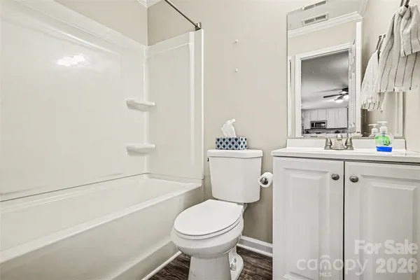 a bathroom with a sink toilet vanity and shower
