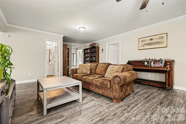 a living room with furniture a flat screen tv and a couch