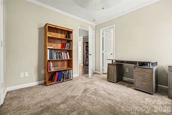 a view of a bedroom with furniture and closet
