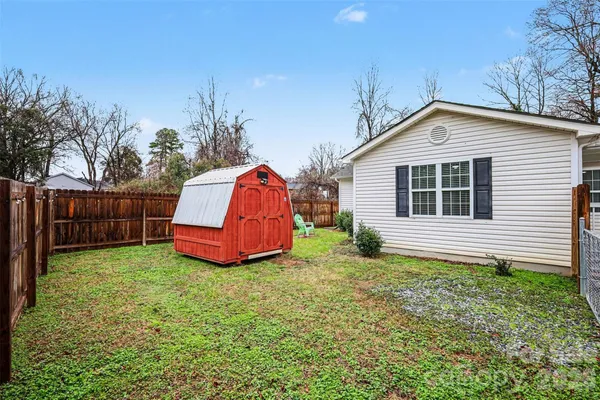 a backyard of a house with wooden fence
