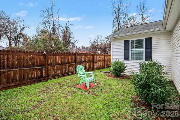 a view of backyard with swimming pool and deck