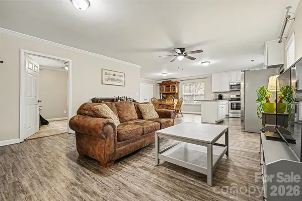 a living room with furniture and kitchen view