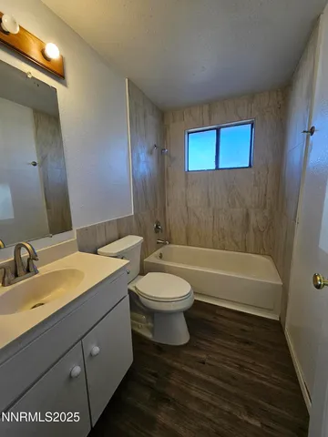 a bathroom with a toilet a sink and bathtub