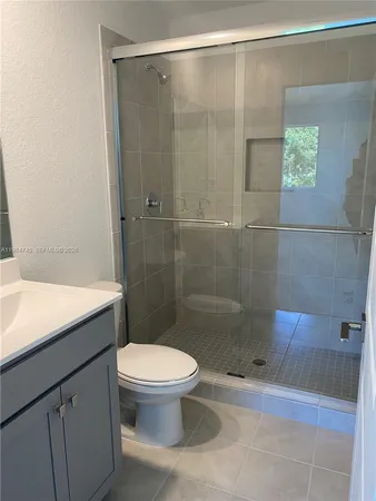 a bathroom with a shower and a toilet
