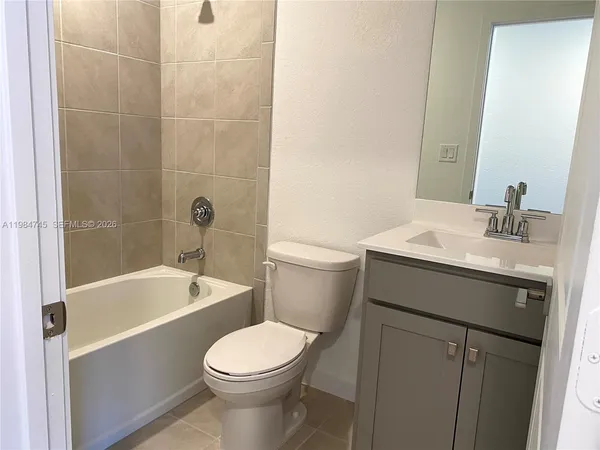 a bathroom with a sink a toilet and bathtub