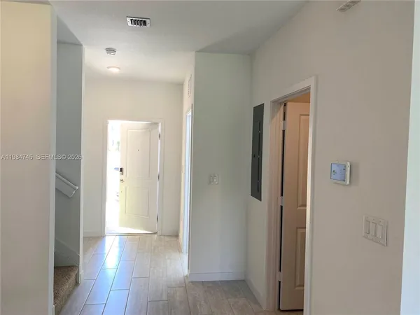 a view of a hallway with wooden floor