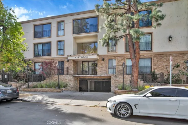 a car parked in front of a brick house