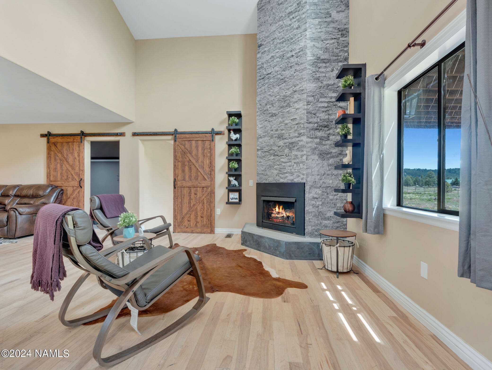 15312 Rabbit Brush Road Parks, AZ 86018 - Photo 16 of 59 a living room with furniture a fireplace and a table