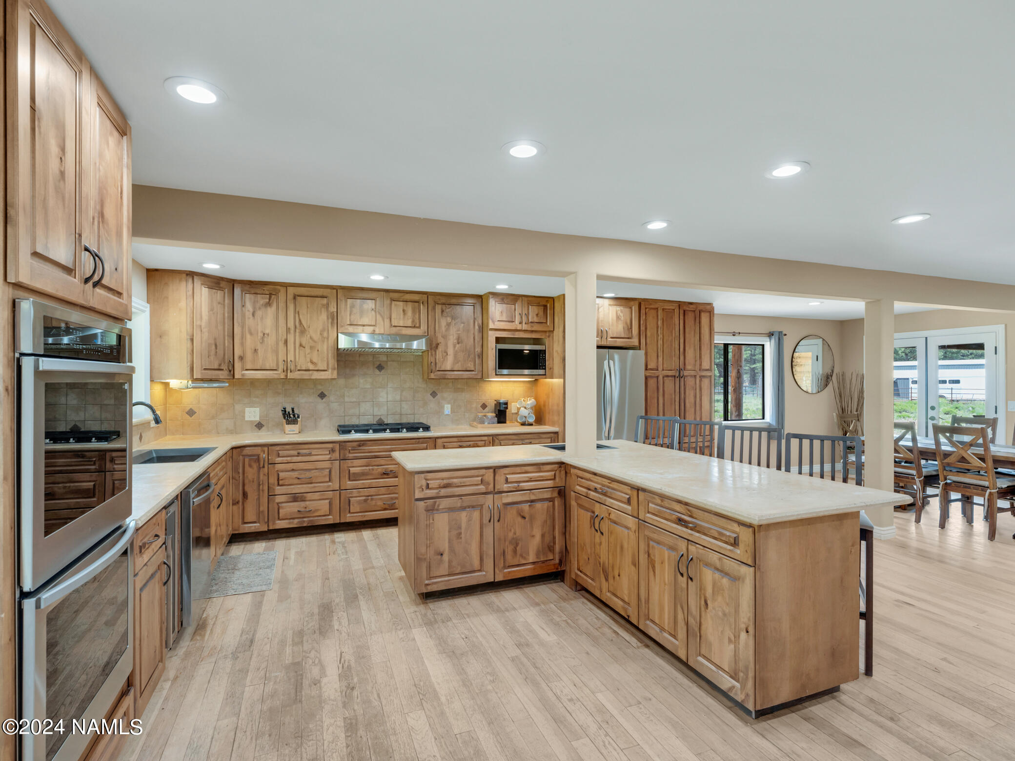 15312 Rabbit Brush Road Parks, AZ 86018 - Photo 18 of 59 a large kitchen with stainless steel appliances granite countertop a large counter top and a stove