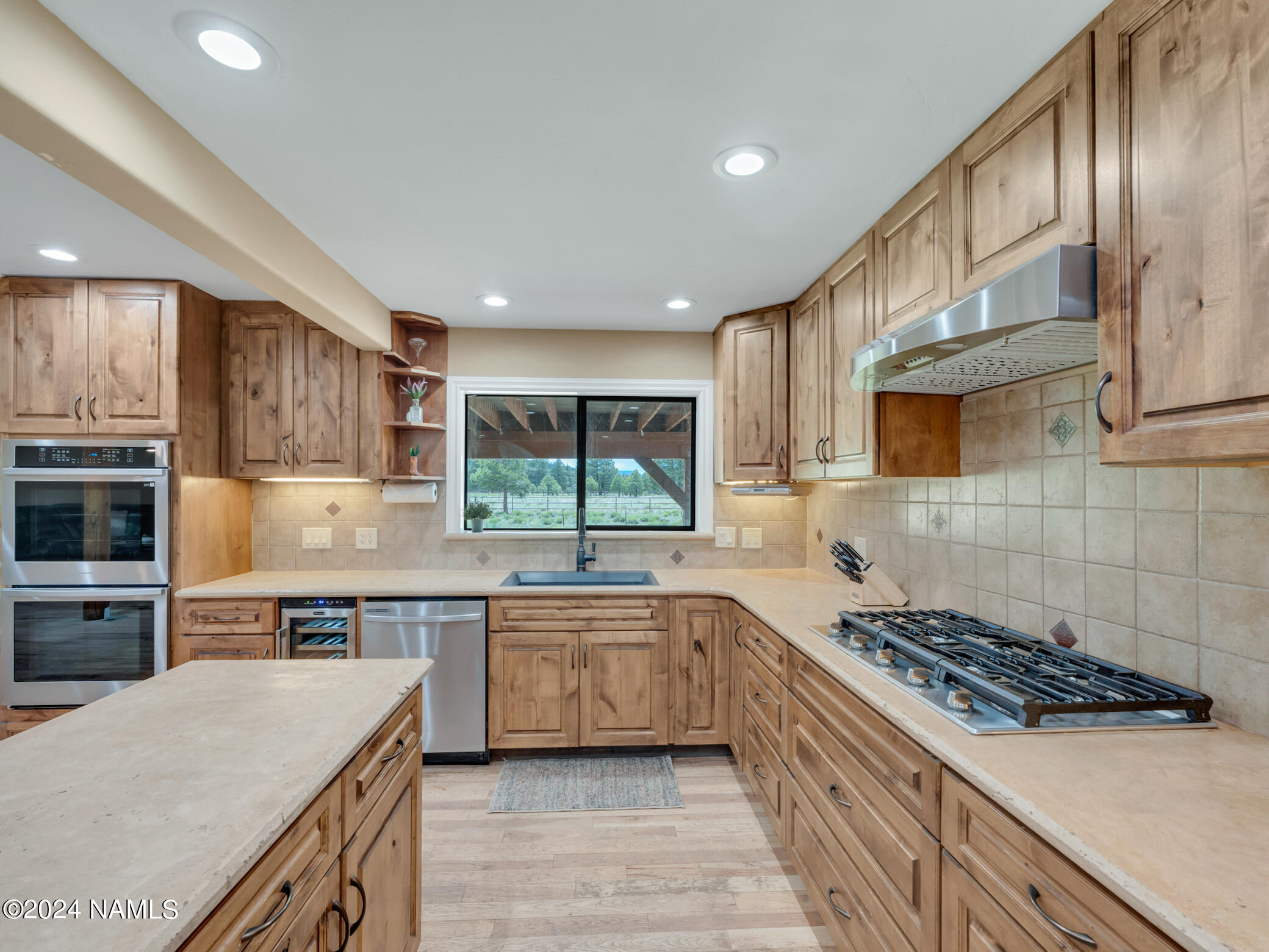 15312 Rabbit Brush Road Parks, AZ 86018 - Photo 21 of 59 a kitchen with stainless steel appliances a sink a stove top oven a counter space and cabinets