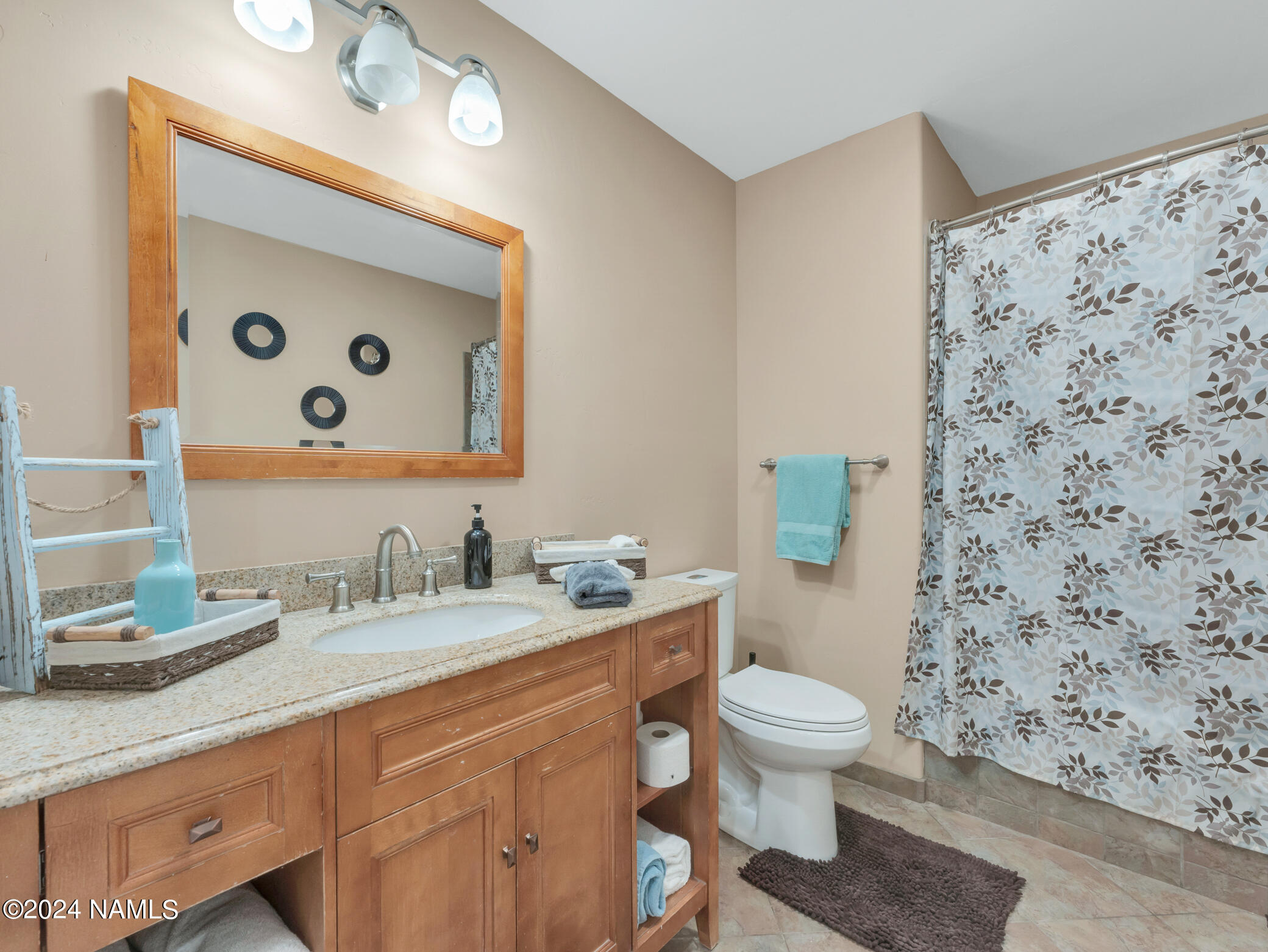 15312 Rabbit Brush Road Parks, AZ 86018 - Photo 31 of 59 a bathroom with a toilet sink and mirror