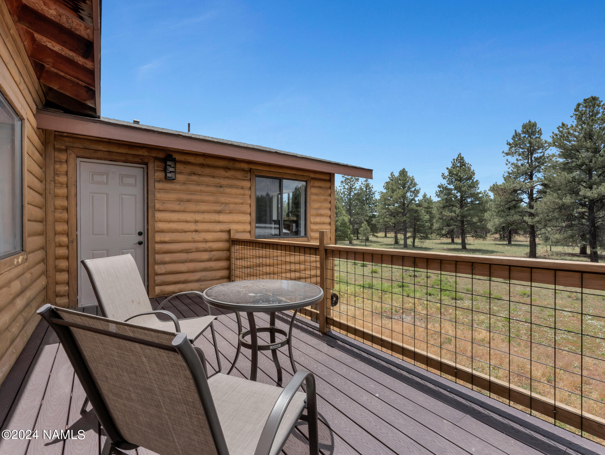 15312 Rabbit Brush Road Parks, AZ 86018 - Photo 34 of 59 a view of balcony with wooden floor and outdoor seating