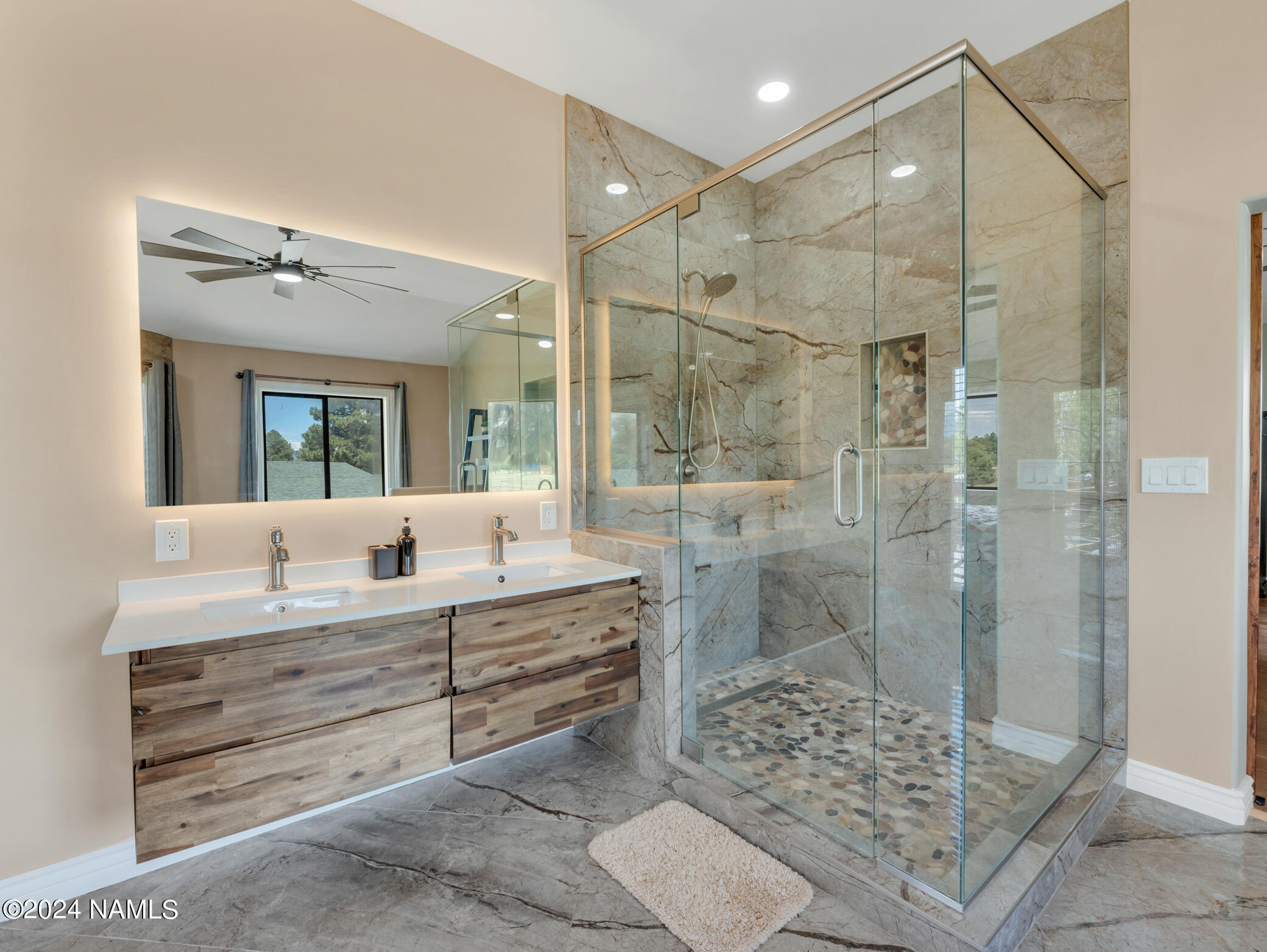 15312 Rabbit Brush Road Parks, AZ 86018 - Photo 40 of 59 a bathroom with a double vanity sink mirror and shower
