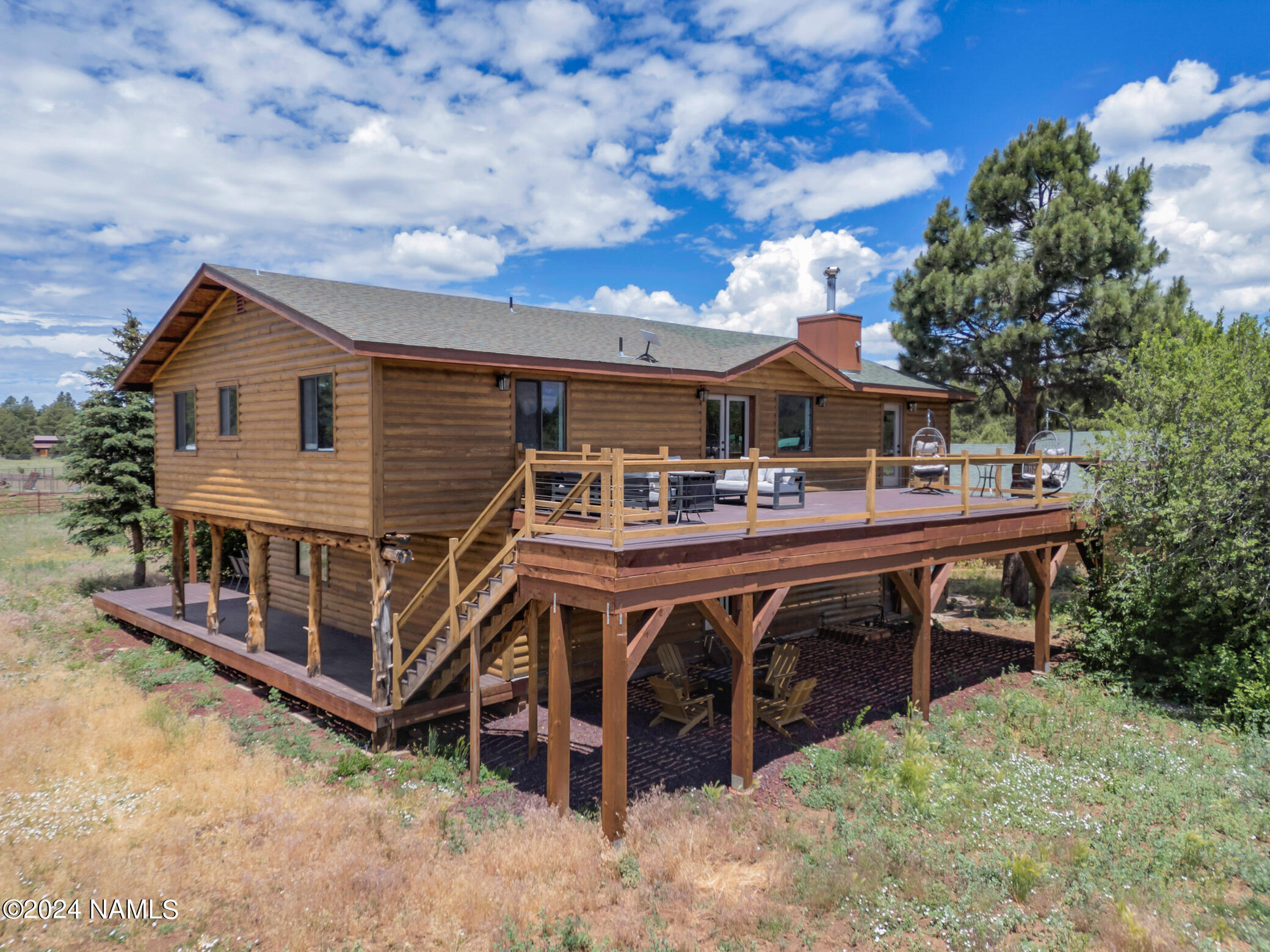 15312 Rabbit Brush Road Parks, AZ 86018 - Photo 4 of 59 a view of a house with wooden deck and furniture