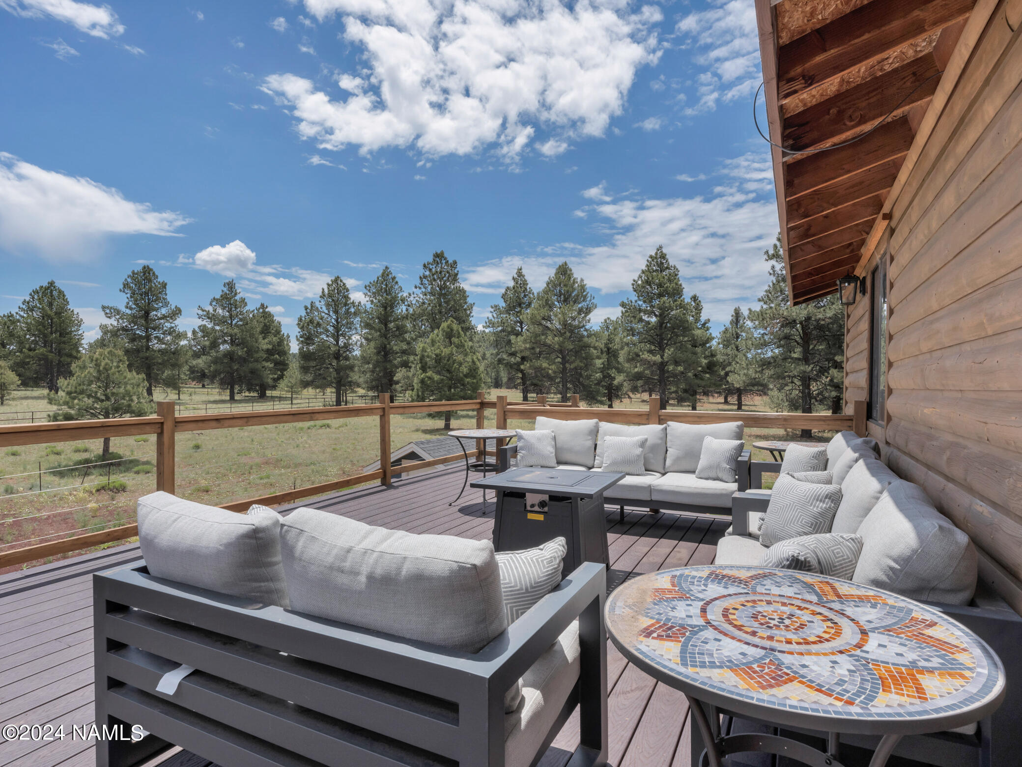 15312 Rabbit Brush Road Parks, AZ 86018 - Photo 42 of 59 a terrace with outdoor seating and trees