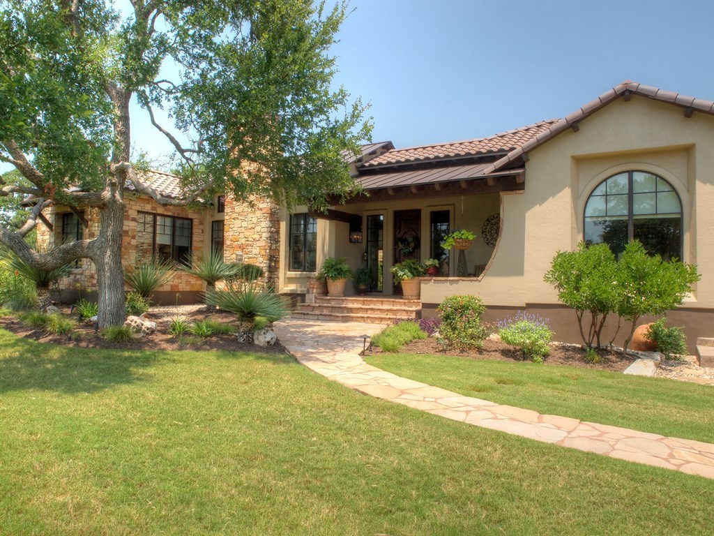 a front view of a house with garden