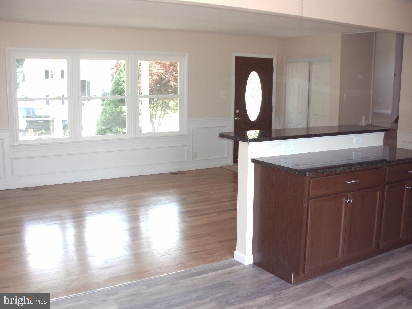 232 Oakfield Drive Newark, DE 19713 - Photo 4 of 14 a view of a living room with wooden floor and a window