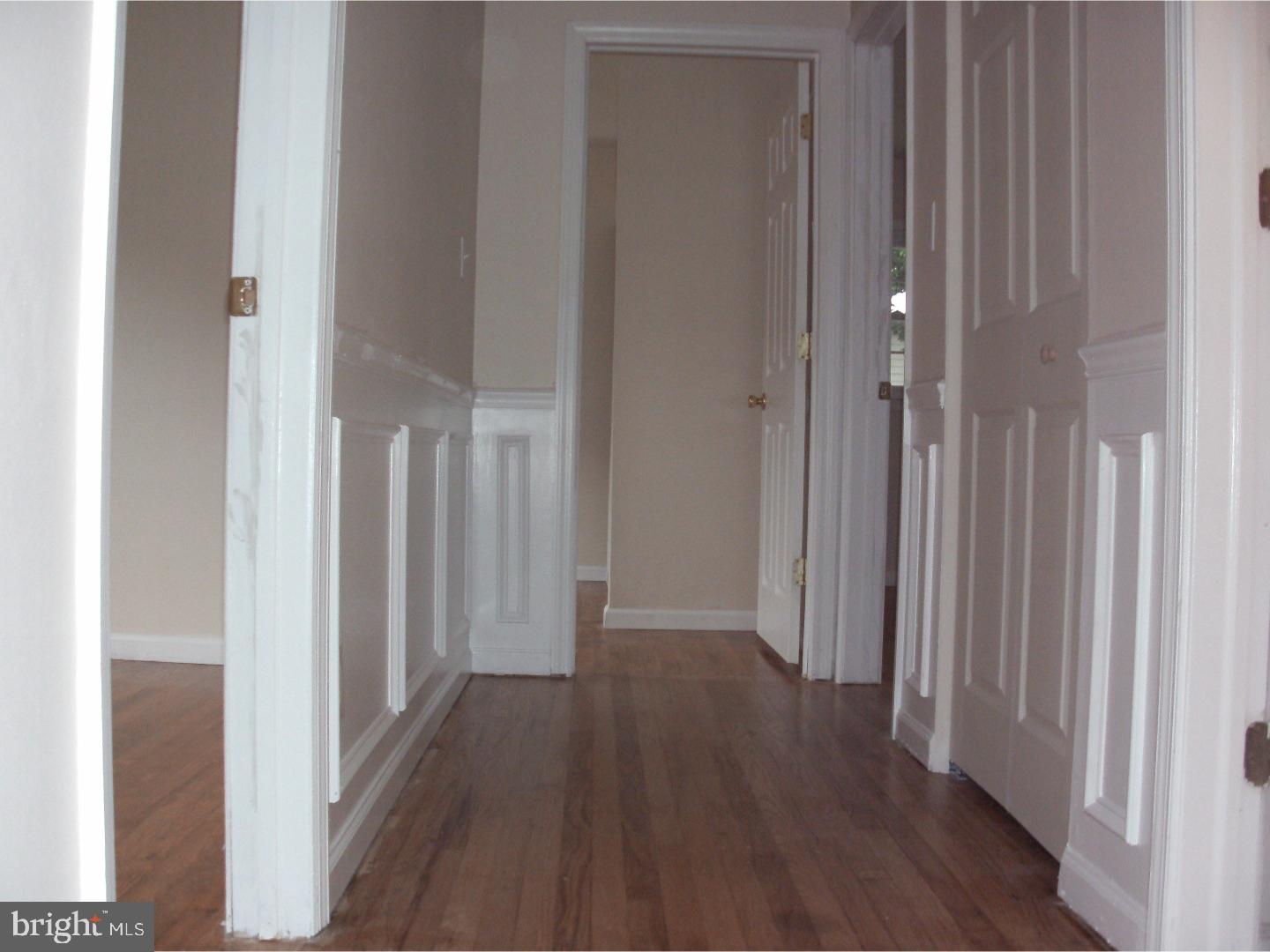 232 Oakfield Drive Newark, DE 19713 - Photo 7 of 14 a view of a hallway with wooden floor