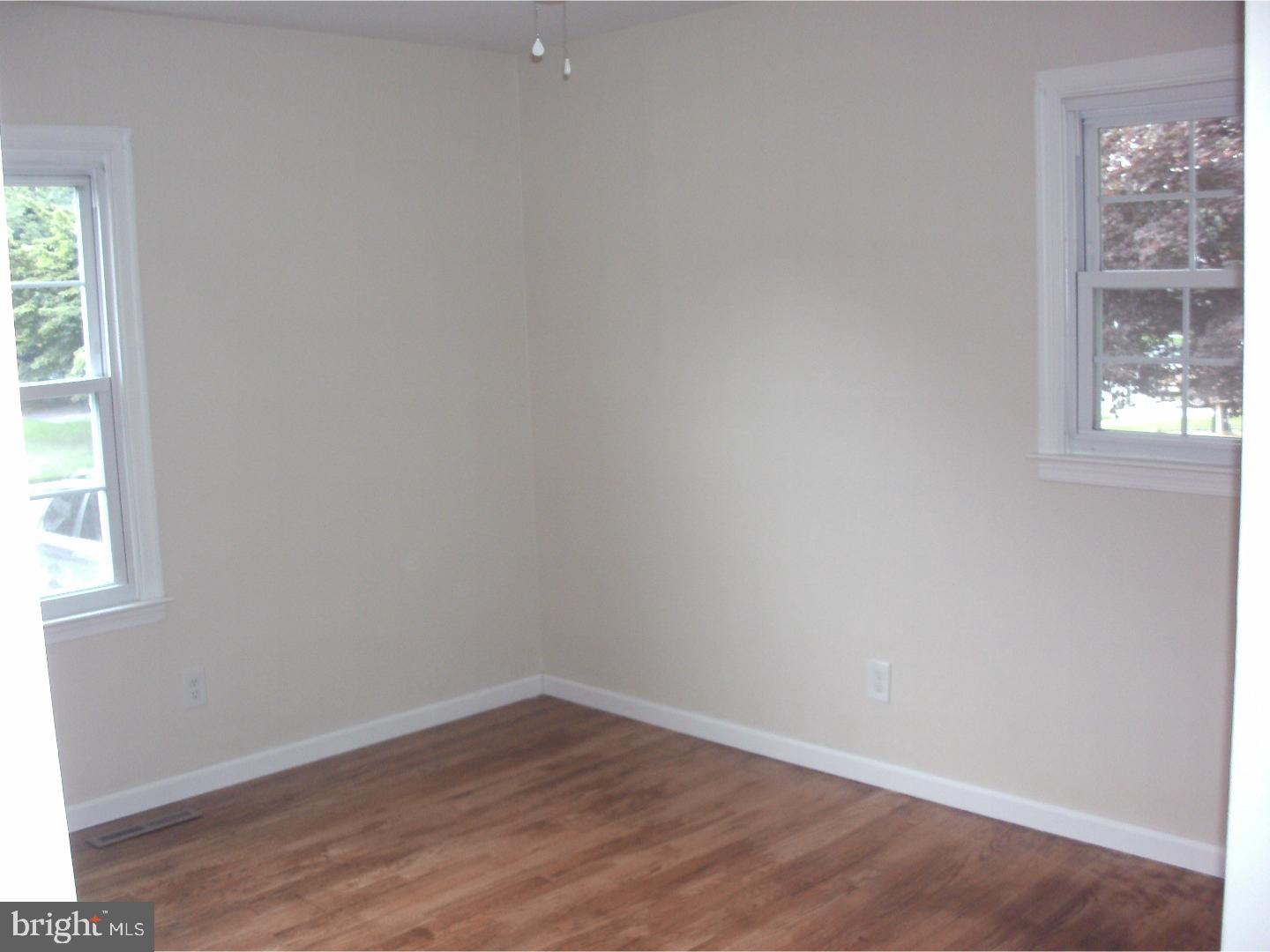 232 Oakfield Drive Newark, DE 19713 - Photo 9 of 14 an empty room with wooden floor and windows