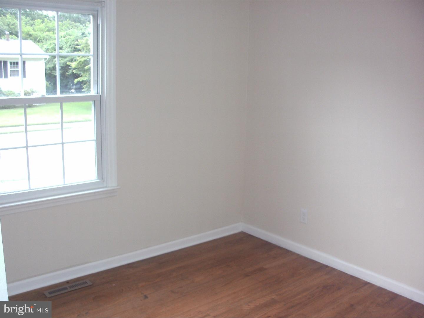 232 Oakfield Drive Newark, DE 19713 - Photo 10 of 14 an empty room with wooden floor and windows