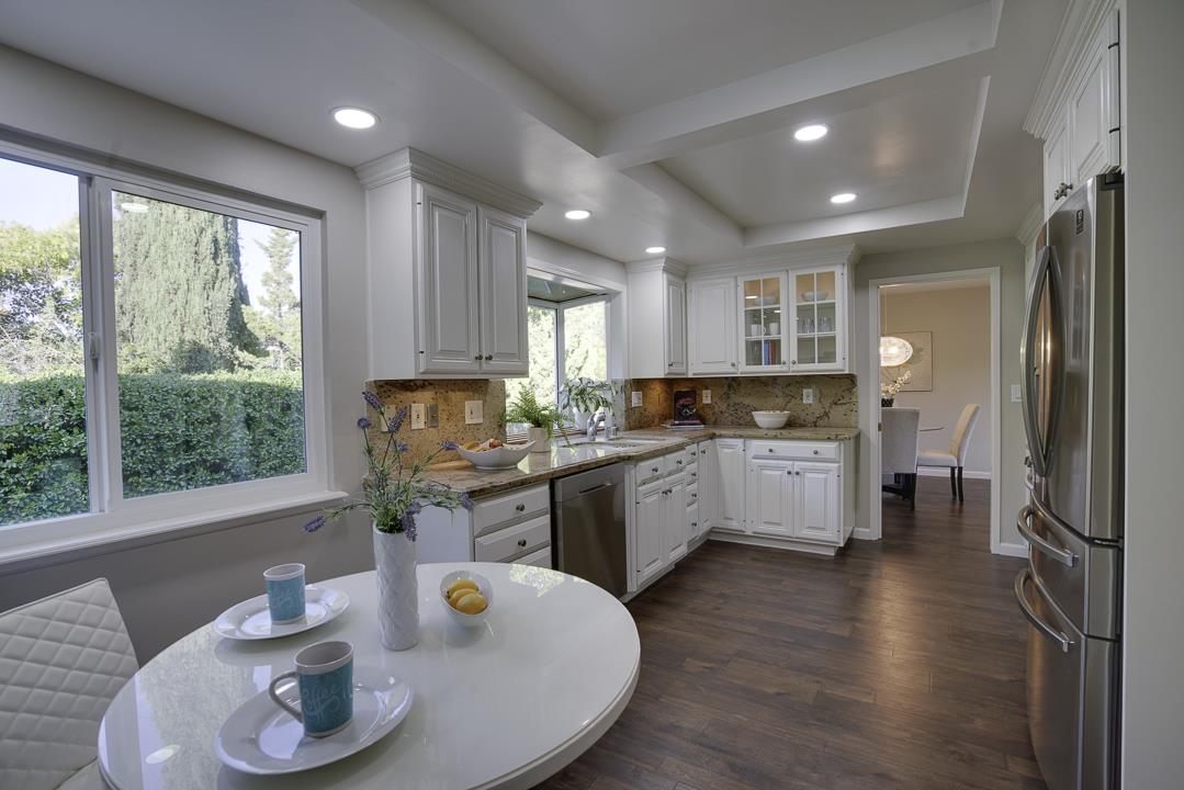 2576 Toltec Circle San Ramon, CA 94583 - Photo 9 of 37 a kitchen with stainless steel appliances granite countertop a refrigerator a sink a stove with wooden cabinets and wooden floor