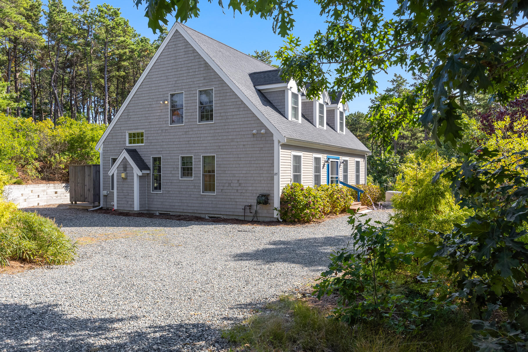 a view of a house with a tree in front of it