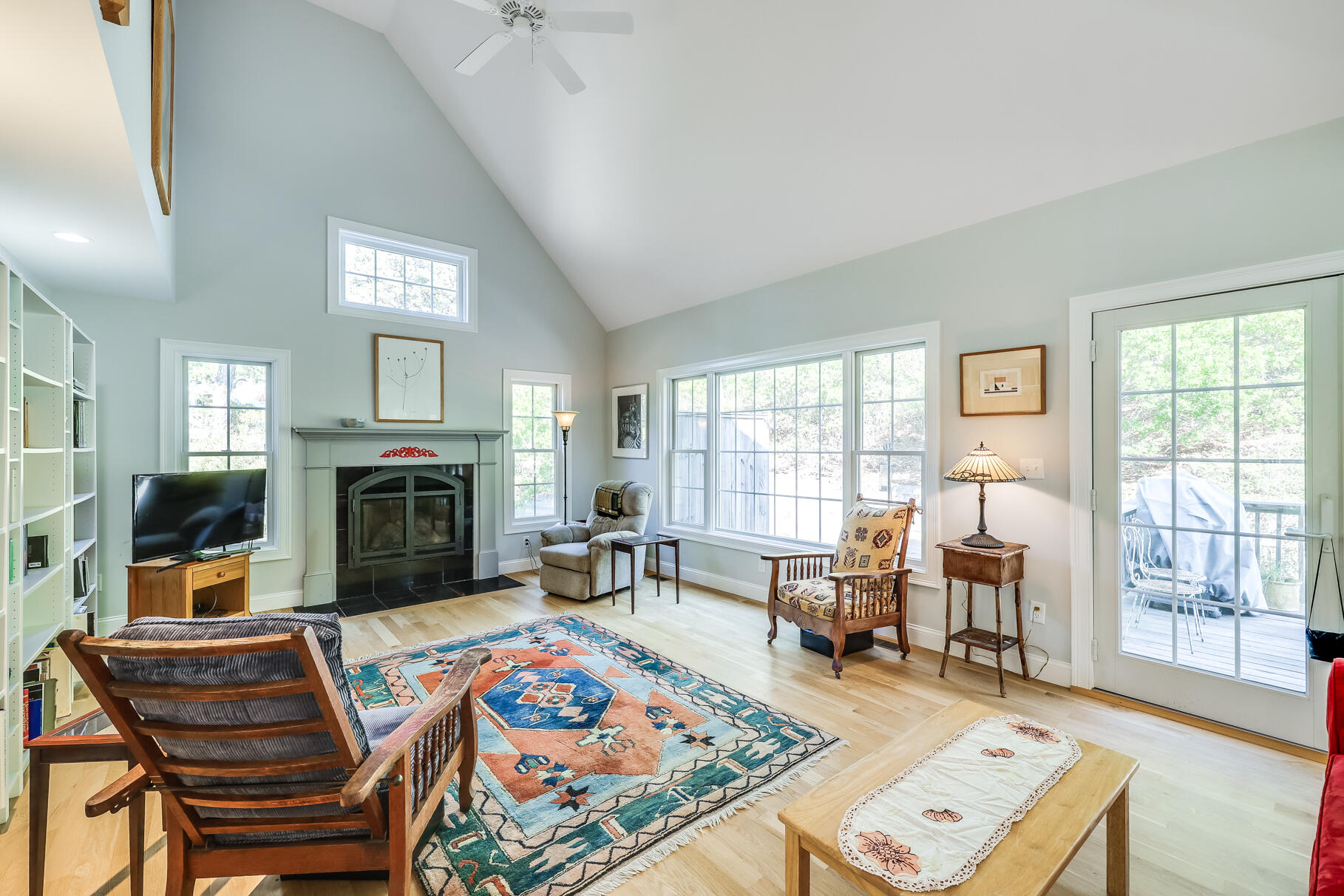 105 High Meadow Road Wellfleet, MA 02667 - Photo 19 of 52 a living room with furniture a fireplace and large windows