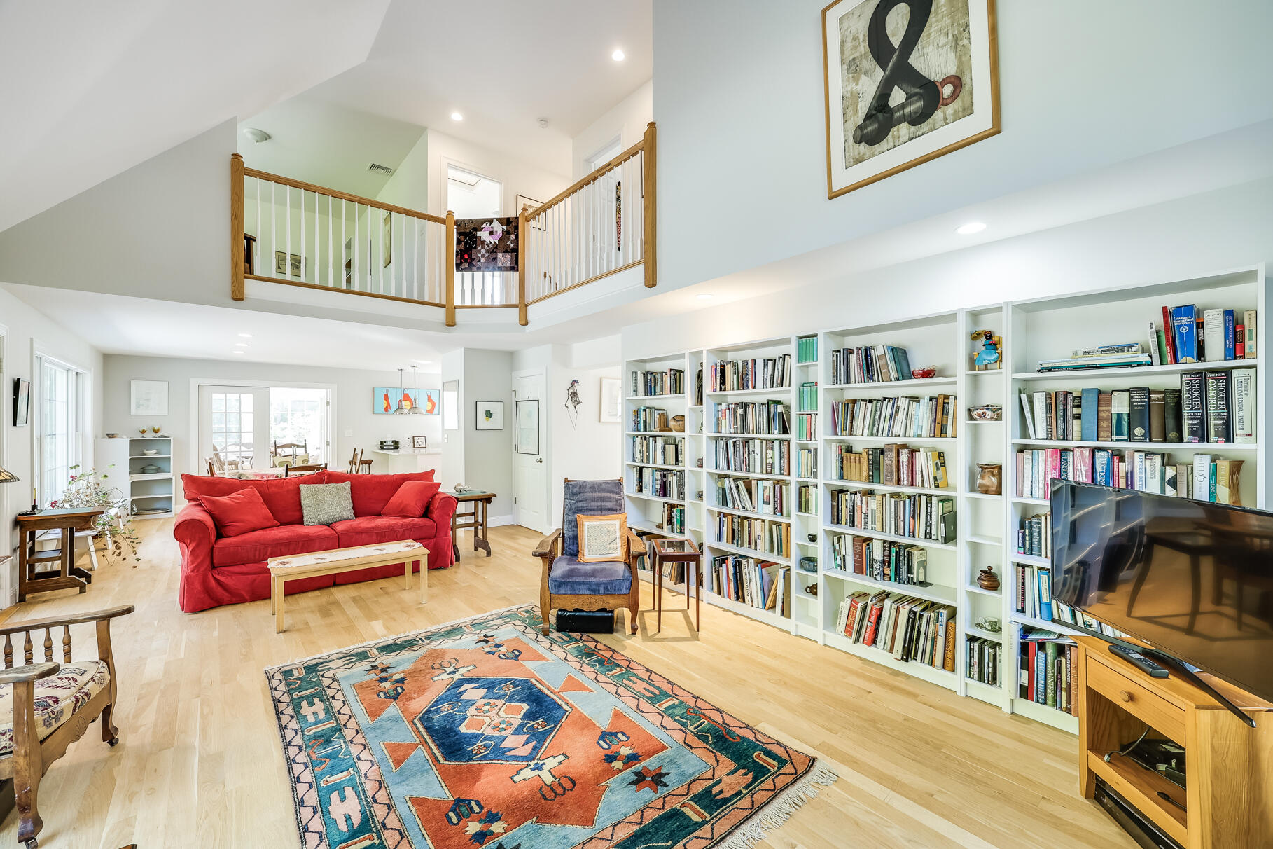 105 High Meadow Road Wellfleet, MA 02667 - Photo 24 of 52 a living room with furniture book shelf and a book shelf