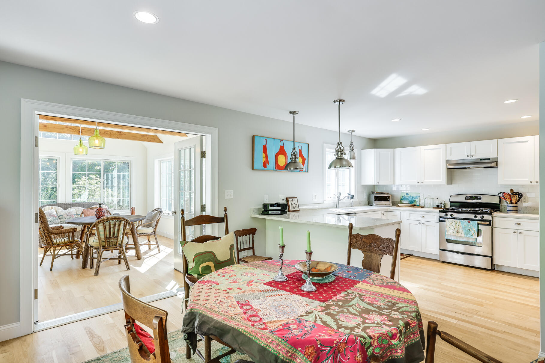 105 High Meadow Road Wellfleet, MA 02667 - Photo 28 of 52 a open kitchen with stainless steel appliances granite countertop a stove top oven a dining table and chairs with wooden floor