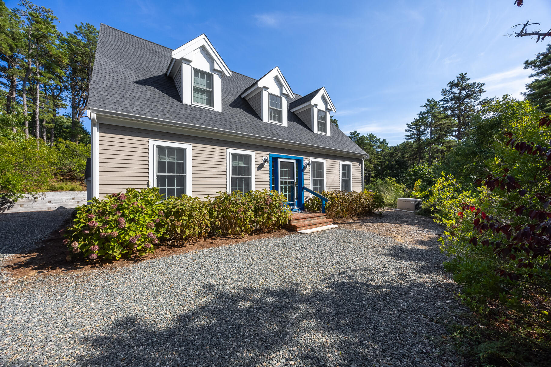 105 High Meadow Road Wellfleet, MA 02667 - Photo 3 of 52 a front view of a house with a garden