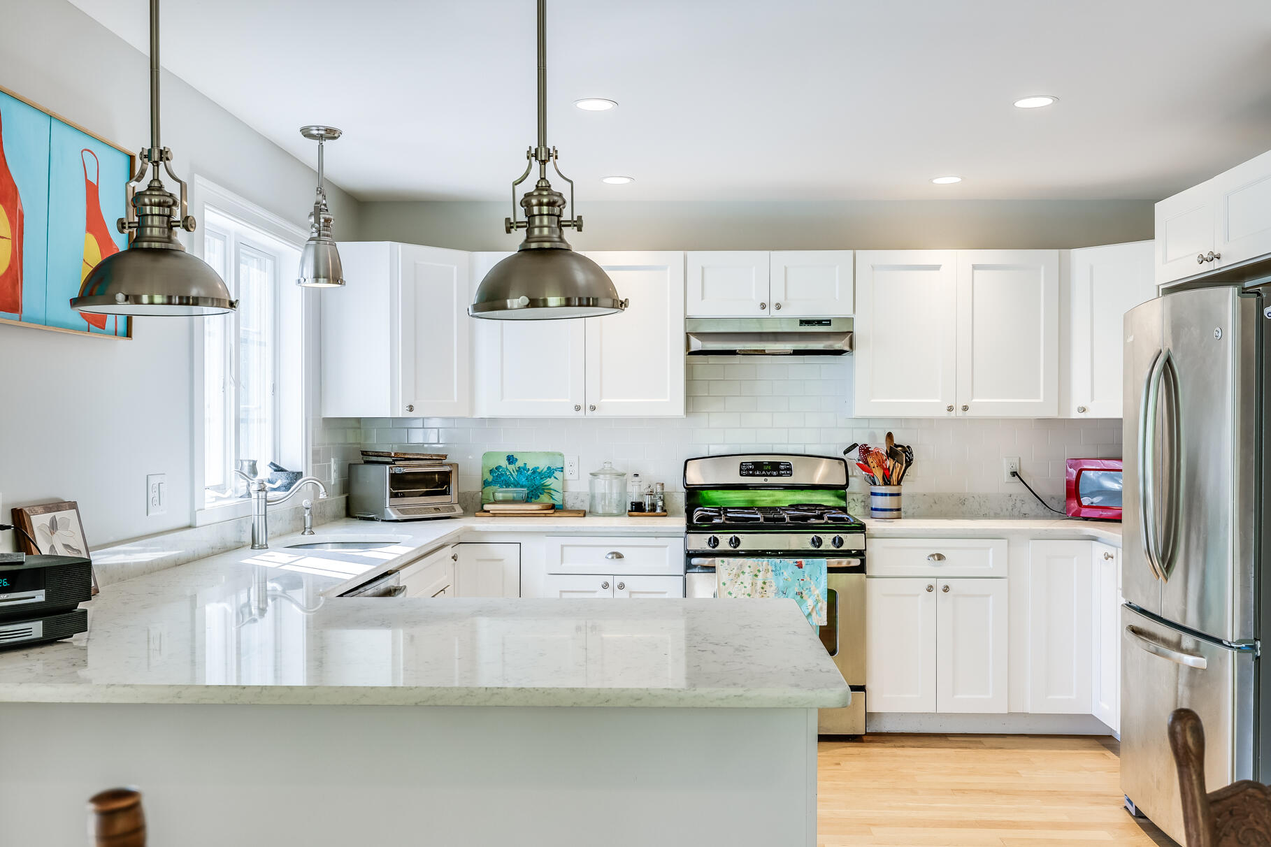105 High Meadow Road Wellfleet, MA 02667 - Photo 31 of 52 a kitchen with stainless steel appliances granite countertop a refrigerator a stove and white cabinets with wooden floor