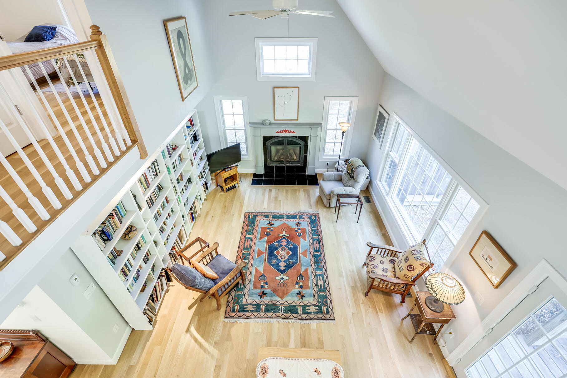 105 High Meadow Road Wellfleet, MA 02667 - Photo 49 of 52 a living room with furniture a fireplace and a rug