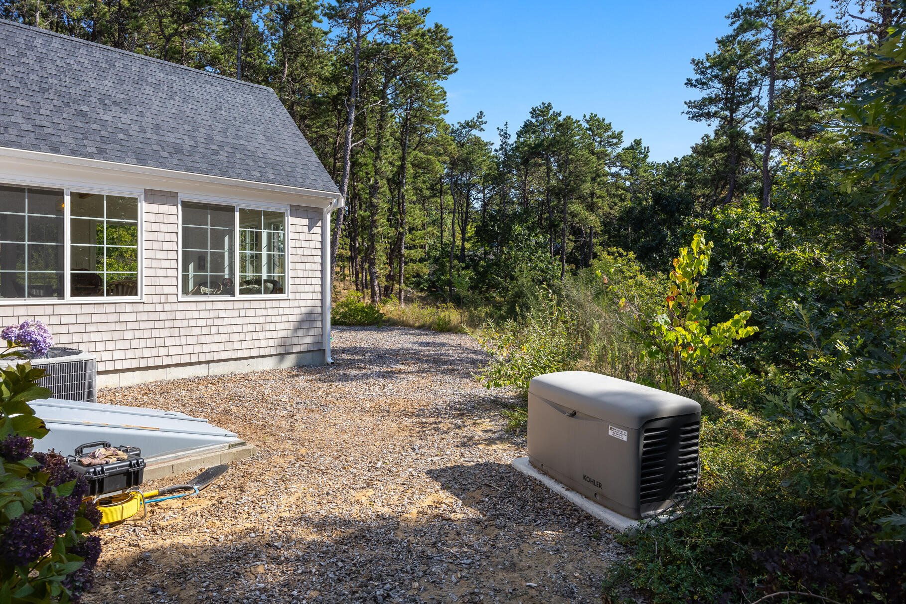 105 High Meadow Road Wellfleet, MA 02667 - Photo 6 of 52 a view of a backyard with sitting area and garden