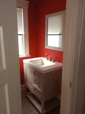 a bathroom with a sink and a window