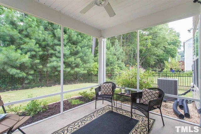 a balcony with furniture and a yard