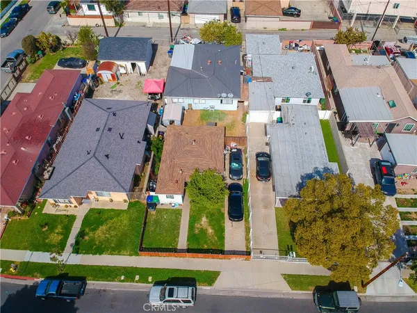 an aerial view of multiple houses with yard